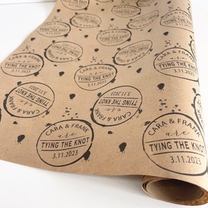 May include: Brown paper gift wrap with a repeating pattern of black ink stamps that say "Cara & Frank are tying the knot 3.11.2023".