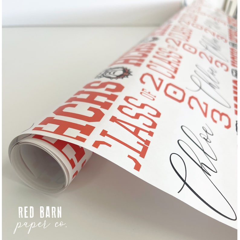 May include: Rolled white paper with red text that reads "TEACHES CLASS OF 2023" and a signature. The paper is from Red Barn Paper Co. The design is suitable for graduation or teacher appreciation gifts.