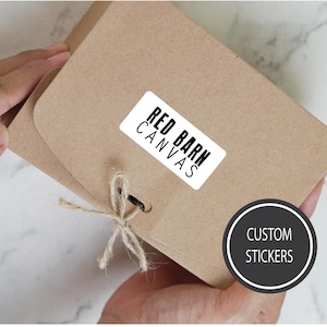 May include: A brown paper package with a white sticker that says "RED BARN CANVAS" and a black circle sticker that says "CUSTOM STICKERS".