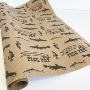 May include: Brown paper wrapping paper with a repeating pattern of black catfish and the text "Smith Family Fish Fry" in a banner.