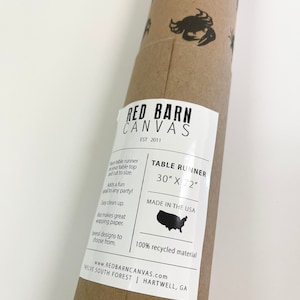 May include: A brown paper tube with a white label that says "Red Barn Canvas Est 2011". The label also says "Table Runner 30" x 72" Made in the USA 100% recycled material www.redbarncanvas.com Twelve South Forest | Hartwell, GA".