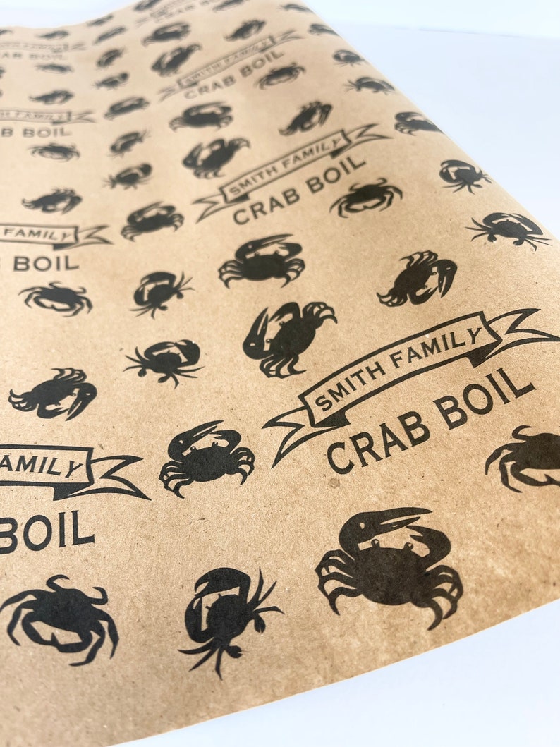 May include: Brown paper wrapping paper with a repeating pattern of black crabs and the text "Smith Family Crab Boil".