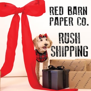May include: A small dog wearing a red and black plaid shirt and a red bow is standing in front of a stack of brown gift boxes with the text "Red Barn Paper Co." and "Rush Shipping" printed in black.