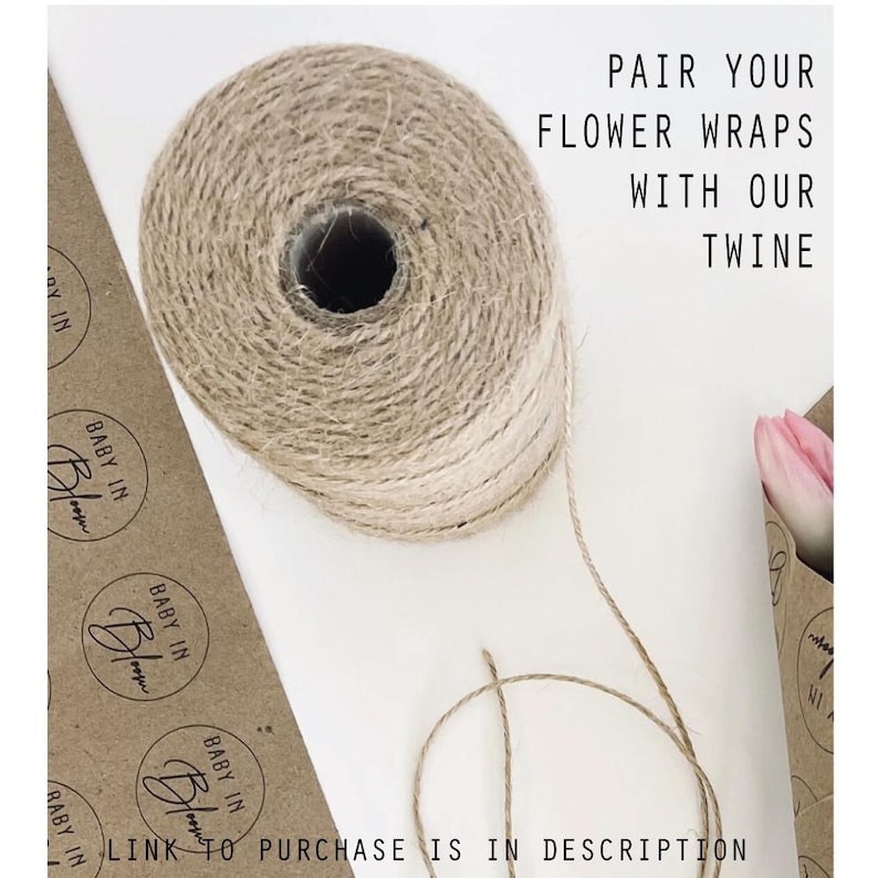 May include: A roll of natural twine with a brown and beige color gradient. The twine is on a white surface with brown paper wrapping with the text "BABY IN BLOOM" printed on it. The text "PAIR YOUR FLOWER WRAPS WITH OUR TWINE" is printed in black on a white background. The text "LINK TO PURCHASE IS IN DESCRIPTION" is printed in black on a white background.