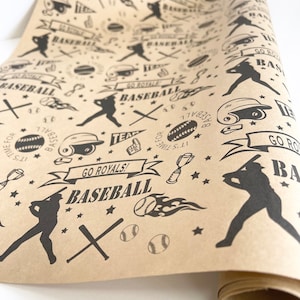 May include: Brown wrapping paper with a black and white baseball themed pattern. The pattern includes baseball bats, baseballs, baseball gloves, and the words "BASEBALL" and "GO ROYALS!"