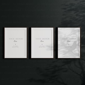 May include: Three black framed picture frames with white mats and the text "YOUR DESIGN Here" and "C2 Atelier Mockup Store" on a dark gray background.
