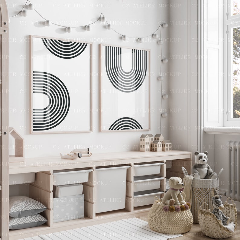 May include: Two framed black and white geometric prints of abstract arches hang on a white wall above a wooden shelf with storage bins. The shelf is filled with toys, including stuffed animals, a toy airplane, and wooden blocks.