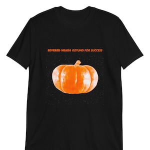 May include: Black t-shirt with the text "Severed Heads Rotund for Success" and an orange pumpkin graphic.