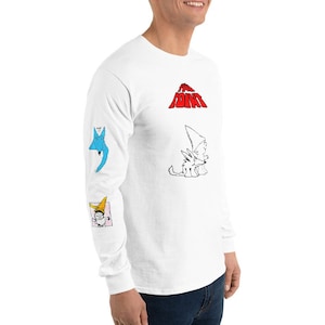 Puede incluir: Camiseta blanca de manga larga con un gráfico rojo de la palabra "The Point" en la parte delantera. Las mangas presentan ilustraciones de dibujos animados azules, blancas y amarillas.
