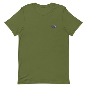May include: A green short-sleeved t-shirt with a small embroidered fish design on the left chest.