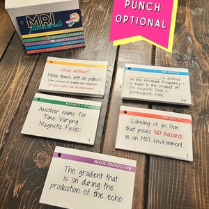 May include: A set of colourful flashcards with rounded corners and hole punches. The flashcards are labelled with the terms "MRI flashcards", "Magnets + Scanners", "Image Production", "MRI Physics", "MRI Safety", "What Artifact?", "Another name for Time Varying Magnetic Fields:", "The gradient that is on during the production of the echo:", "is defined as the resonant frequency &rarr; is equal to the product of the magnetic field &rarr; gyromagnetic ratio.", and "Labeling of an item that poses NO hazards in an MRI environment."