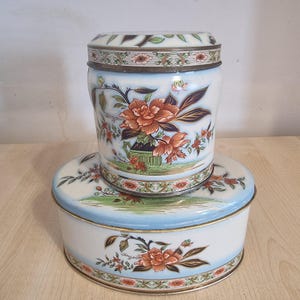 Round and oval vintage storage tins with flower design