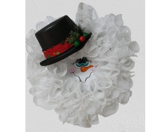 This adorable, whimsical, lighted snowman wreath for use as a winter, Christmas/Holiday decoration. Will entertain all season.