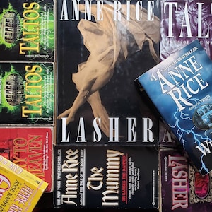 May include: A collection of paperback books by Anne Rice, including titles like "Lasher", "The Witching Hour", "The Mummy", and "Taltos".