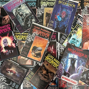 May include: A collection of comic books featuring the horror character Hellraiser. The covers feature various illustrations of the character, including a demon with hooks, a creature with a human face, and a skull with a crown. The comic books are all in various states of wear and tear, with some showing signs of age and use.