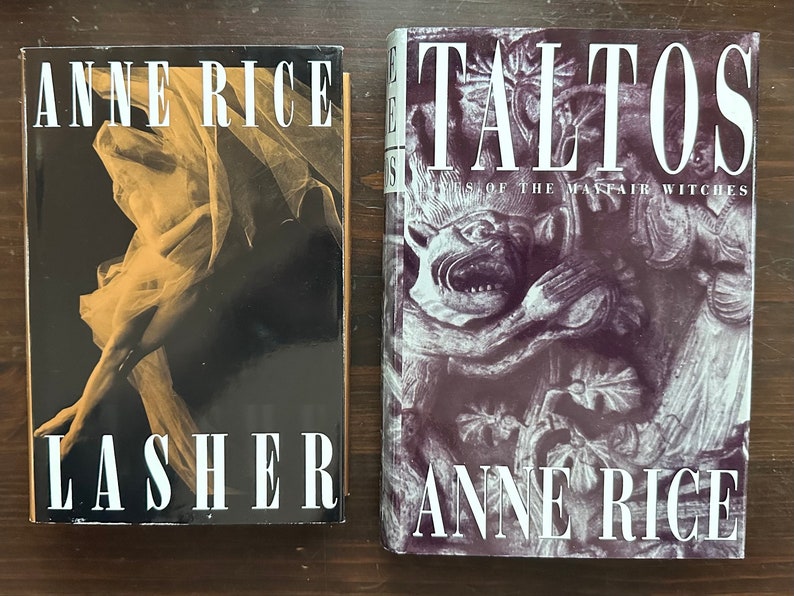 May include: Two paperback books by Anne Rice. The book on the left is titled "Lasher" and features a black and white photo of a woman in a flowing gown. The book on the right is titled "Talisman" and features a black and white photo of a gargoyle.
