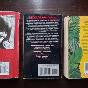 May include: Three paperback books with red, black, and yellow covers. The back covers feature text, barcodes, and ISBN numbers. The book titles are "Ramses the Great Lives...", "Vampire" and "The Club".