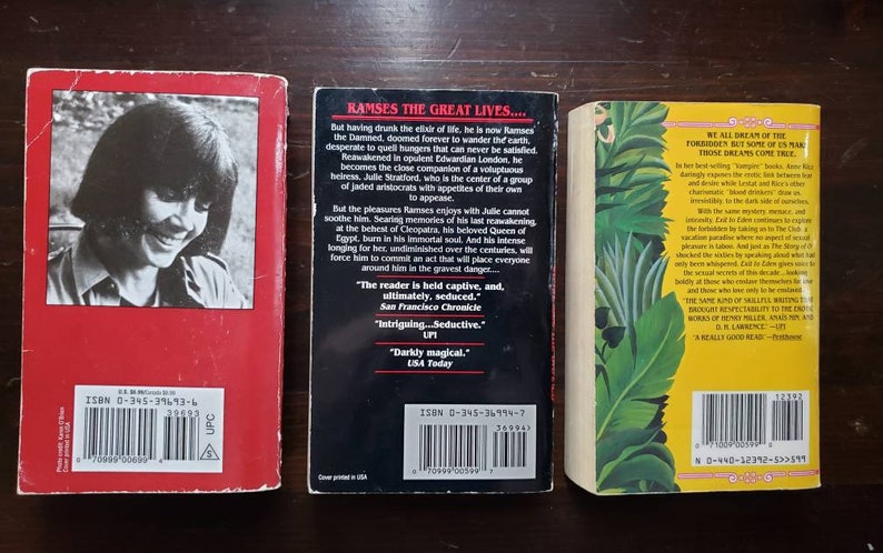 May include: Three paperback books with red, black, and yellow covers. The back covers feature text, barcodes, and ISBN numbers. The book titles are "Ramses the Great Lives...", "Vampire" and "The Club".