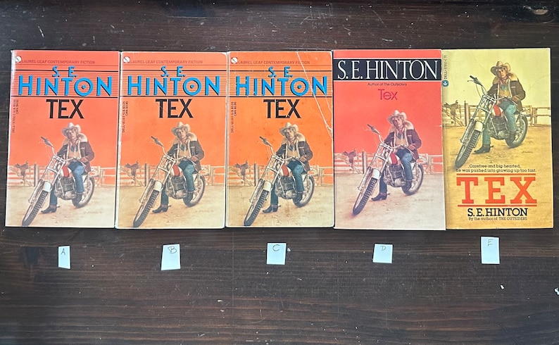 May include: Five paperback books with orange and yellow covers. The books are all titled "Tex" and feature a man riding a motorcycle on the cover. The author is S.E. Hinton, author of "The Outsiders".