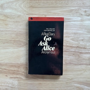May include: A paperback book titled Go Ask Alice by Anonymous with a black cover featuring a close-up of a human eye. The top red banner displays the text Flare Autobiography and The 3 Million Copy Bestseller in white and black lettering.