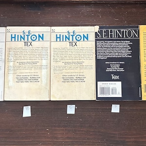 May include: Five paperback books with white covers and black text. The books are all by S.E. Hinton and are titled "Tex". The back covers of the books feature a description of the book and other books by the author.