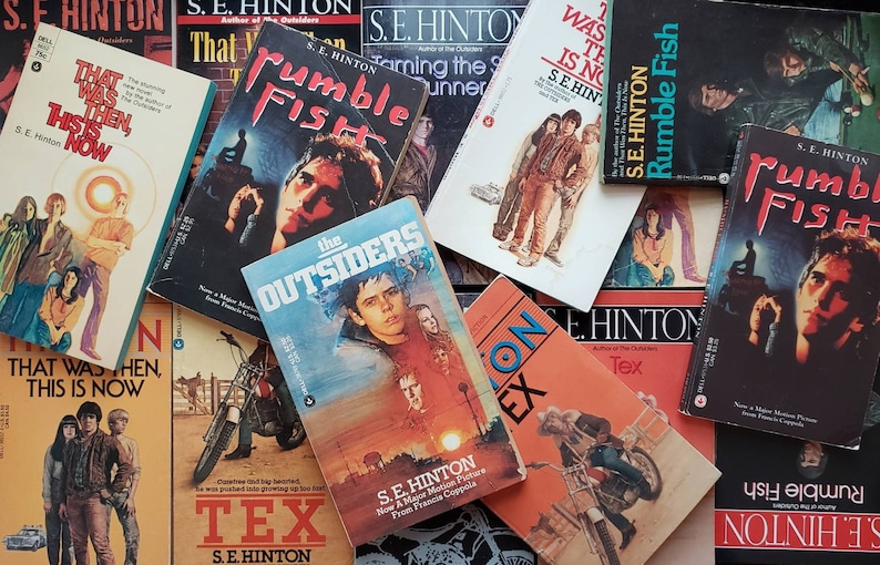May include: A collection of paperback books by S.E. Hinton, including "That Was Then, This Is Now", "Rumble Fish", "The Outsiders", "Tex", and "Rumble Fish".