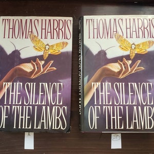 May include: Two copies of the book "The Silence of the Lambs" by Thomas Harris. The book cover features a hand holding a death's-head hawkmoth.