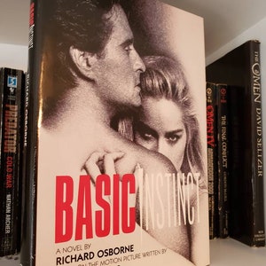 May include: A paperback novel titled "Basic Instinct" by Richard Osborne. The cover features a black and white photo of a man and woman embracing.