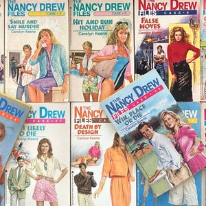 May include: A collection of ten Nancy Drew Files paperback books with colorful covers featuring young women and various scenes. The books are stacked in two rows, with the titles and authors visible. The titles include "Deadly Intent", "Smile and Say Murder", "Hit and Run Holiday", "False Moves", "Circle of Evil", "Till Death Do Us Part", "Most Likely to Die", "Death by Design", "Win, Place or Die", and "Out of Bounds".