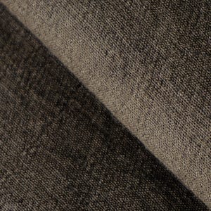 May include: Close-up of a folded section of dark brown fabric. The fabric has a textured, woven appearance, with visible threads and a slightly rough surface. The color varies from dark brown to a lighter, muted brown.