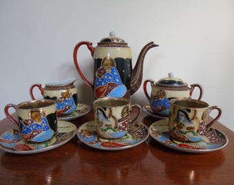 Fine china Japanese part set coffee set. guilt lined cups. Coffee pot. Three cups and saucers, Cream Jug and sugar bowl and lid. 1970s.