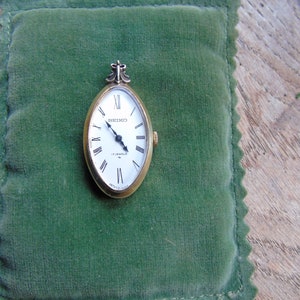A Seiko gold pendant watch, Made in the 70s. In full working order,  in lovely condition. Marked Japan 21-04518. 17 jewel. keeps good time.