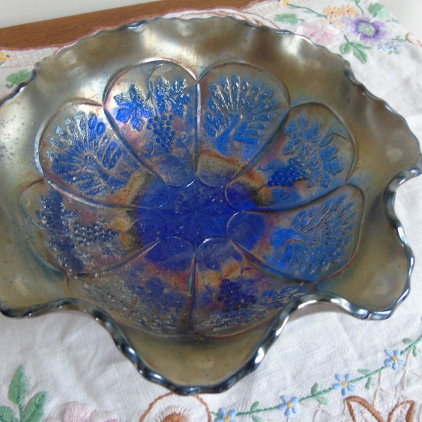 A Blue Fenton Carnival glass fluted bowl. Decorated with grapes and peacocks. In good condition for its age, no nibbles or chips