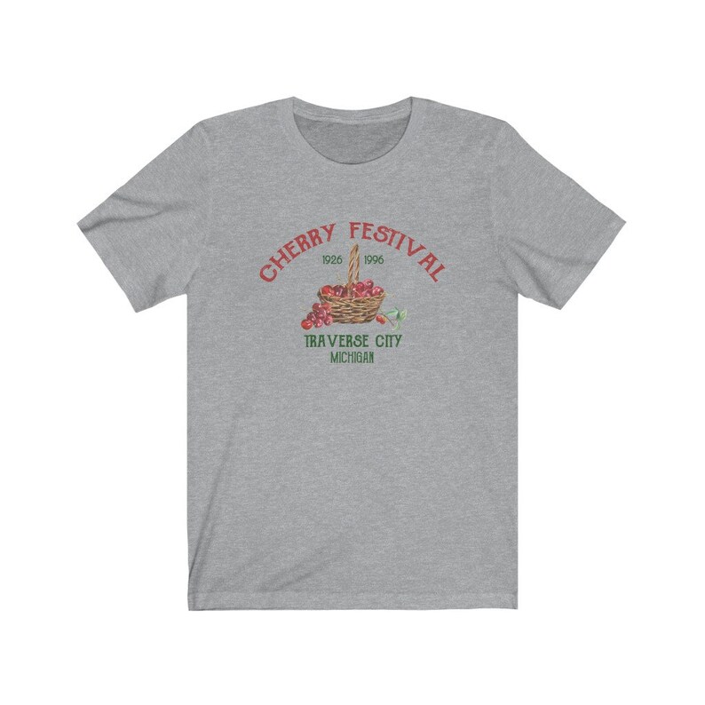 May include: Gray t-shirt with a red graphic of a basket of cherries and the text "CHERRY FESTIVAL 1926 1996 TRAVERSE CITY MICHIGAN".