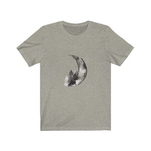 May include: A heather grey t-shirt with a black and white watercolor design of a crescent moon with a forest inside.
