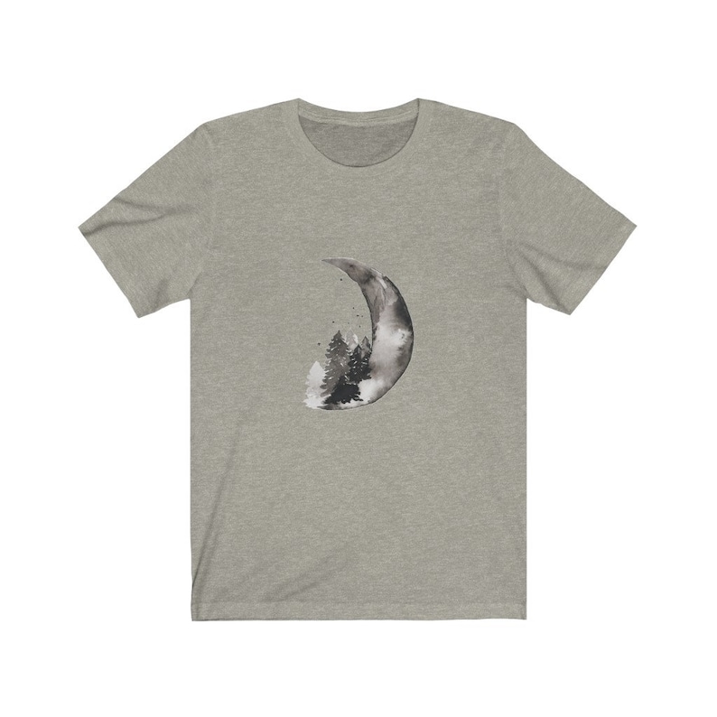 May include: A heather grey t-shirt with a black and white watercolor design of a crescent moon with a forest inside.