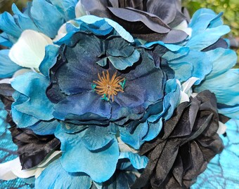 May include: A bouquet of blue and black fabric flowers. The flowers are arranged in a cluster and have a realistic appearance.