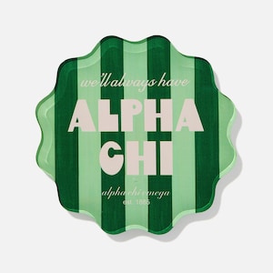 May include: A green and white striped decorative item with a scalloped edge. The text "we'll always have ALPHA CHI alpha chi omega est. 1885" is displayed in a light color.