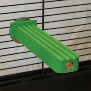 May include: A bright green, ridged pet cage accessory, likely a perch or platform. It is attached to the cage bars with a metal fitting and a bolt. The accessory is designed for small animals.