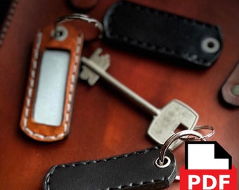 May include: Three leather keychains with stitched edges. One keychain has a blank label, another is black, and the third is black with the word "PDF" printed on it.