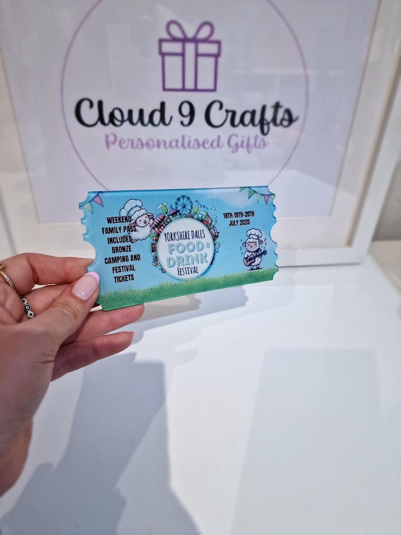 Pu&ograve; includere: Un biglietto blu e bianco per il Festival del Cibo e delle Bevande dello Yorkshire Dales, con una pecora dei cartoni animati e le date dal 18 al 20 luglio 2025.