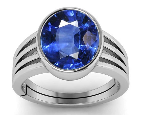 A blue sapphire is displayed on a white surface high res Neelam stone,  Beautiful ring Stock Photo | Adobe Stock