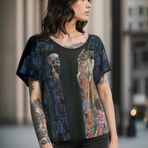May include: A black t-shirt featuring a colourful print of a painting depicting a skeleton and a woman. The print is a mix of blue, green, red and yellow colours.