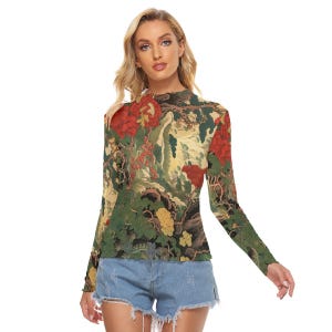 Peut inclure: Un haut &agrave; manches longues avec un imprim&eacute; floral et paysager aux couleurs vives, rouge, vert et jaune. Le haut a un col montant et une coupe ajust&eacute;e, adapt&eacute; au port d&eacute;contract&eacute;.