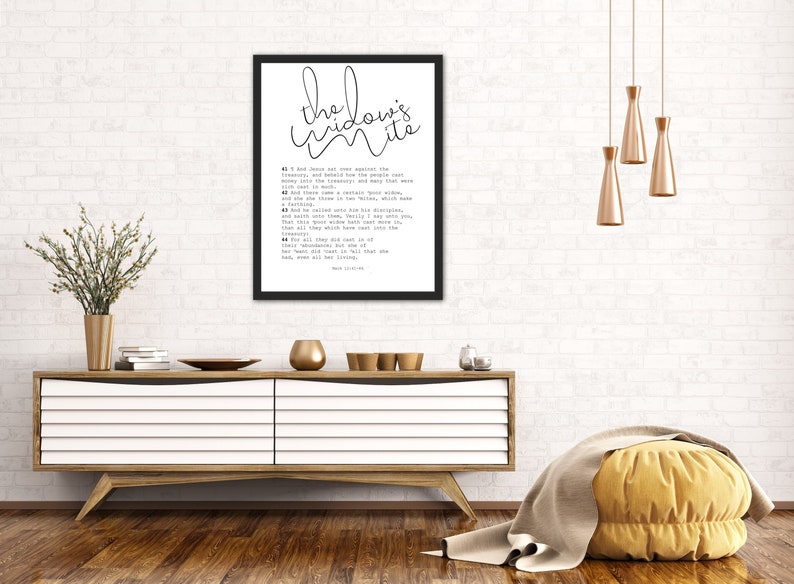 May include: Black and white framed print with the text "the widow's mite" and a bible verse from Mark 12:41-44. The print is hanging on a white brick wall above a wooden dresser.