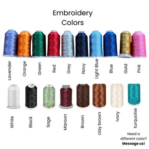 May include: A color chart of embroidery thread spools in various colors, including lavender, orange, green, red, grey, navy, light blue, blue, gold, and pink. Additional colors include white, black, sage, maroon, brown, clay brown, ivory, and turquoise.
