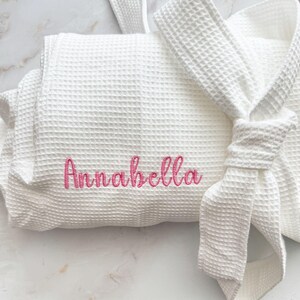 May include: A rustic wooden sign with the text "Welcome to our porch" in white lettering. The sign features a distressed finish and a simple, inviting design, perfect for outdoor decor.