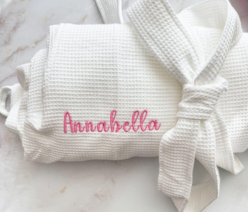 May include: A rustic wooden sign with the text "Welcome to our porch" in white lettering. The sign features a distressed finish and a simple, inviting design, perfect for outdoor decor.
