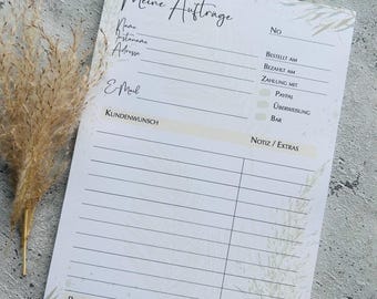 Puede incluir: Un bloc de notas blanco con un diseño floral y el texto "Meine Auftrage" (alemán para "Mis pedidos") en la parte superior. El bloc de notas tiene secciones para la información del cliente, los detalles del pedido, el método de pago y la fecha de envío.