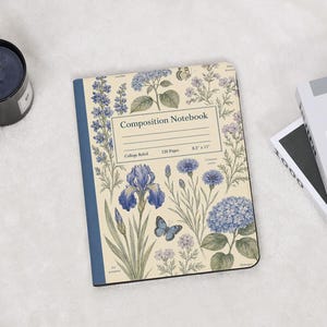 May include: A composition notebook with a cream-colored cover featuring blue floral illustrations, including irises and hydrangeas, and a butterfly. The center label reads Composition Notebook, 120 Pages, College Ruled, and 8.5 x 11 inches.